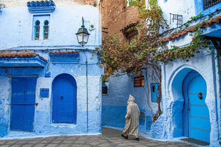 Man walking through the old medina of Chefchaouen, Morocco
