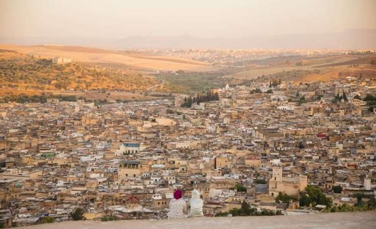 Two local women overlooking the ancient Fes medina at sunset