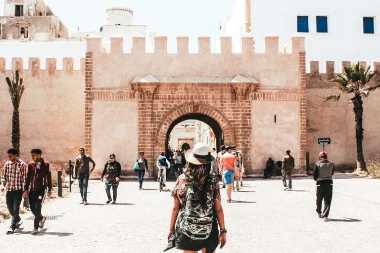 Traveller walking toward a historic gate in Essaouira medina