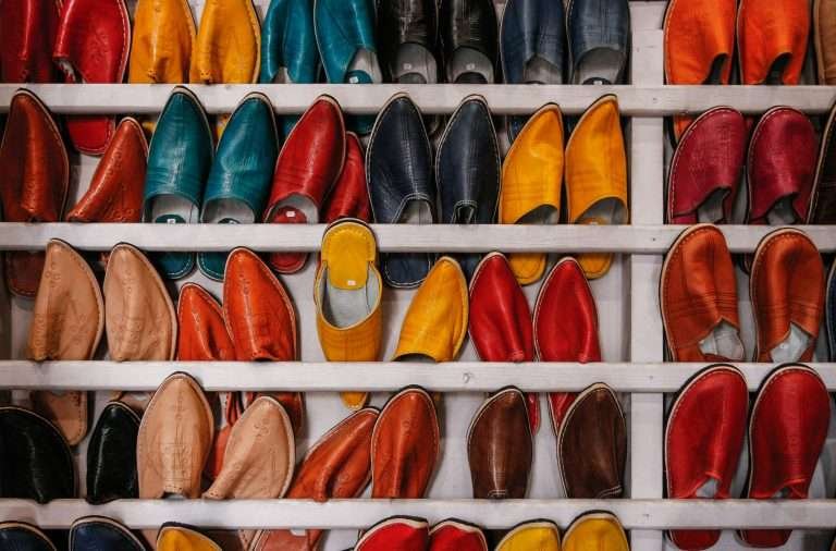 Colourful Moroccan leather slippers displayed in a market stall in the souk