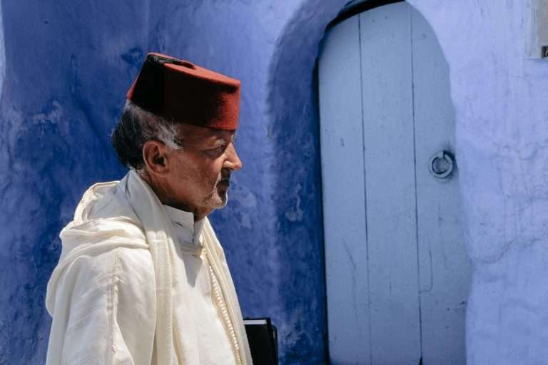 Moroccan man wearing a Fes in the streets of Chefchaouen, Morocco's Blue City