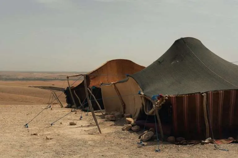 Desert camp tent of a nomad family in a rocky desert landscape in Morocco