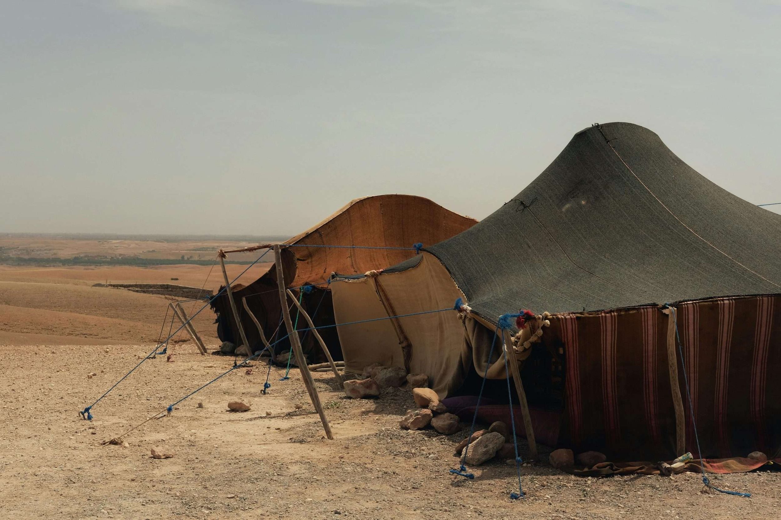 Desert camp tent of a nomad family in a rocky desert landscape in Morocco