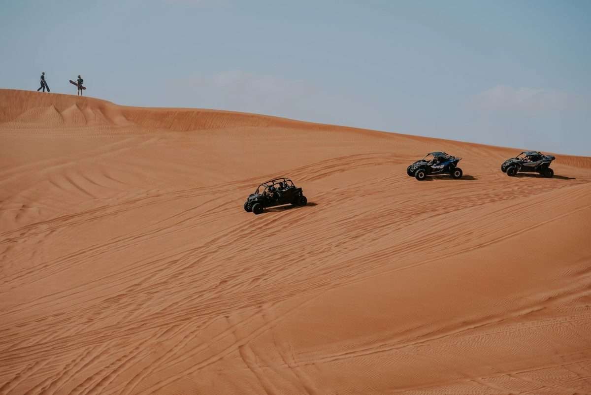 Quad bikes crossing sand dunes in Merzouga's Erg Chebbi Dunes in the Sahara