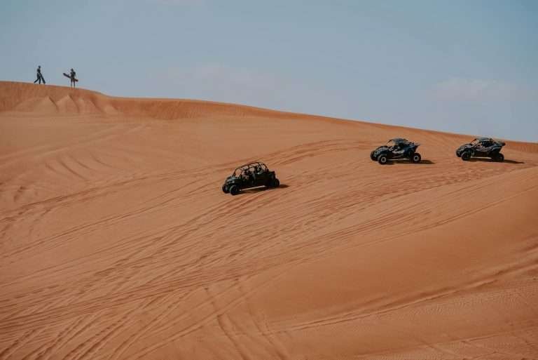 Quad bikes crossing sand dunes in Merzouga's Erg Chebbi Dunes in the Sahara