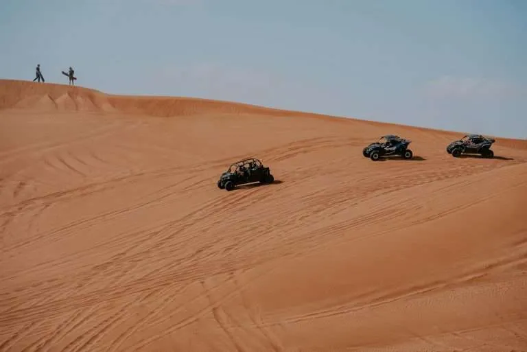 Quad bikes crossing sand dunes in Merzouga's Erg Chebbi Dunes in the Sahara, Moroccan Adventure Holidays