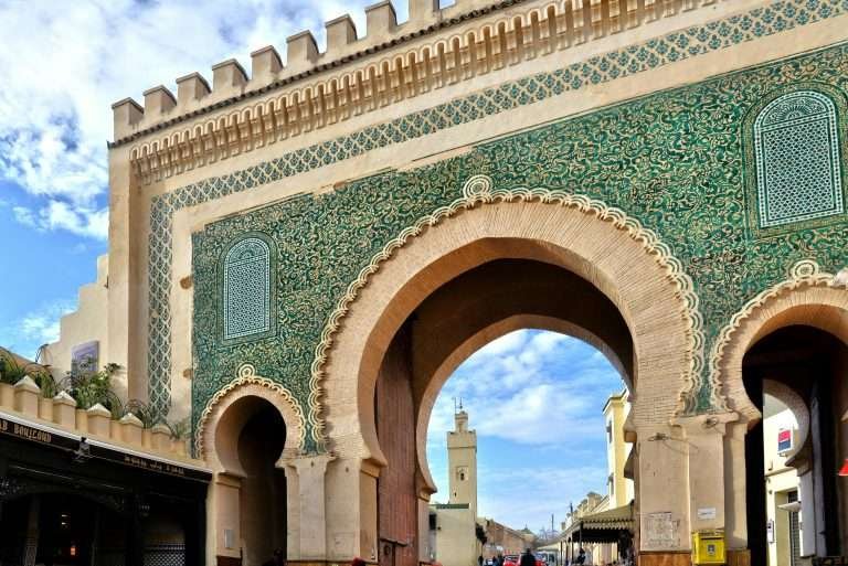 Grand historic gate with green tilework in Fes, Morocco